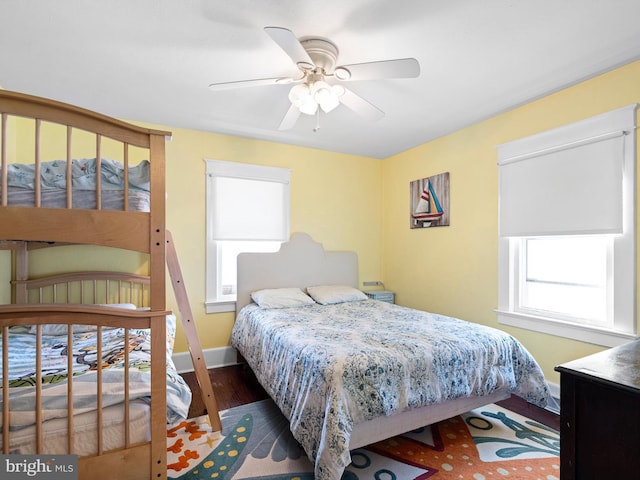 bedroom featuring ceiling fan and dark wood-type flooring