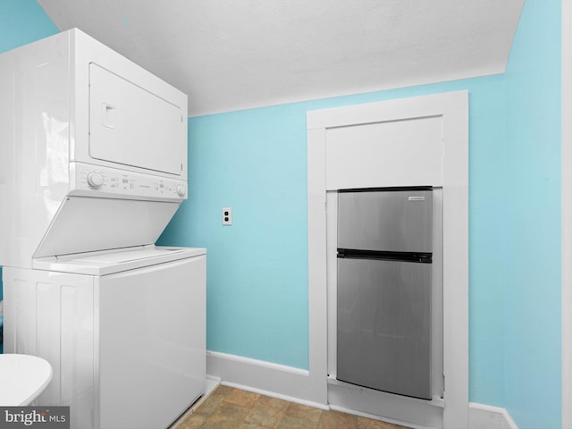 clothes washing area with stacked washer / drying machine