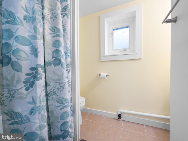 bathroom with tile patterned floors, a shower with curtain, and toilet