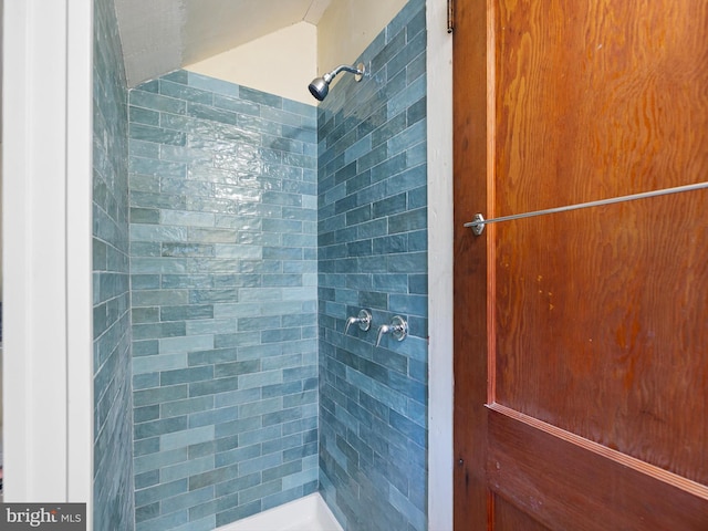 bathroom with tiled shower