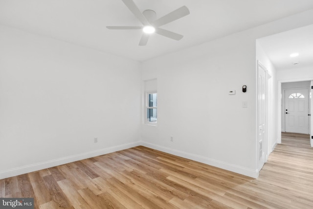 spare room featuring ceiling fan and light hardwood / wood-style flooring