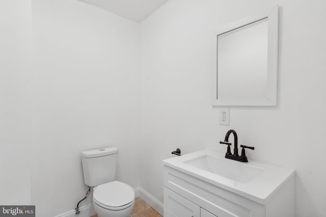 bathroom with tile patterned floors, vanity, and toilet