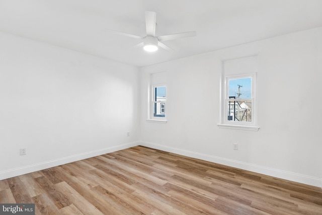 spare room featuring ceiling fan and light hardwood / wood-style flooring