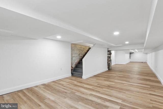 basement with light hardwood / wood-style floors