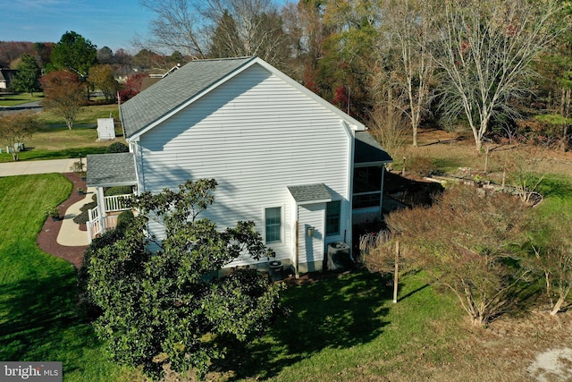 view of side of home featuring a lawn