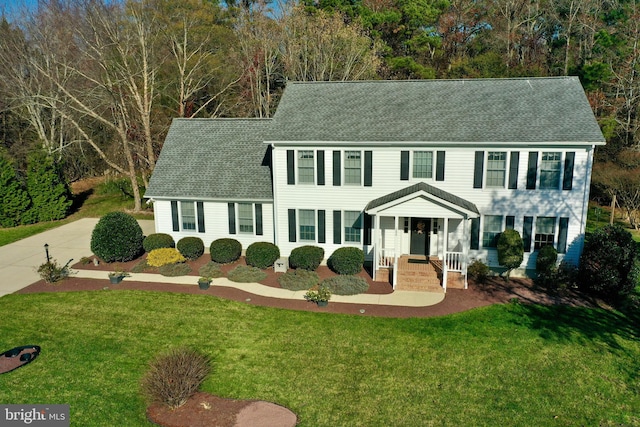 colonial-style house with a front lawn