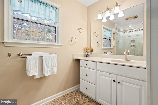 bathroom with tile patterned flooring, vanity, and a shower with shower door