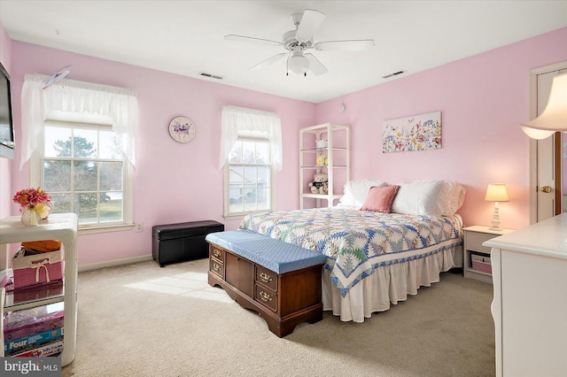 bedroom with ceiling fan, light carpet, and multiple windows