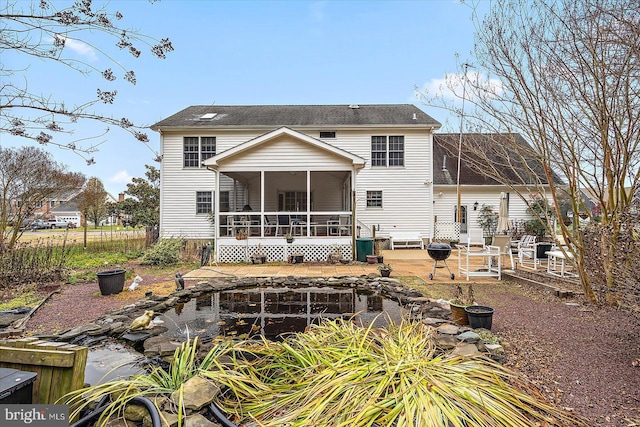 rear view of house featuring a sunroom