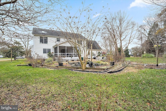 back of house with a lawn