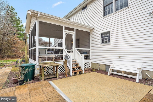 exterior space featuring a patio area and a sunroom