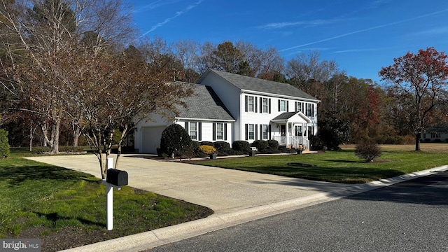 view of front of home featuring a front lawn and a garage