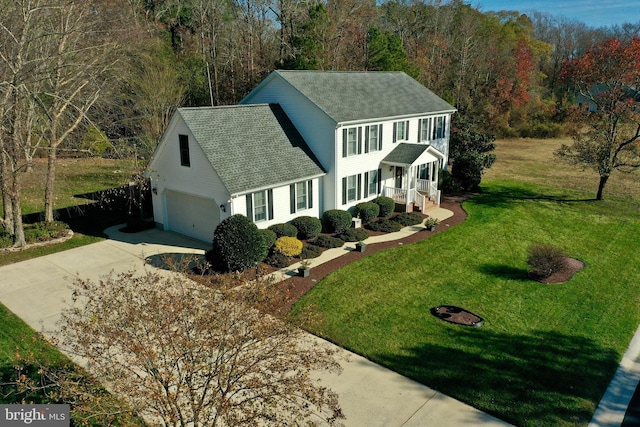 view of front of property with a garage and a front yard