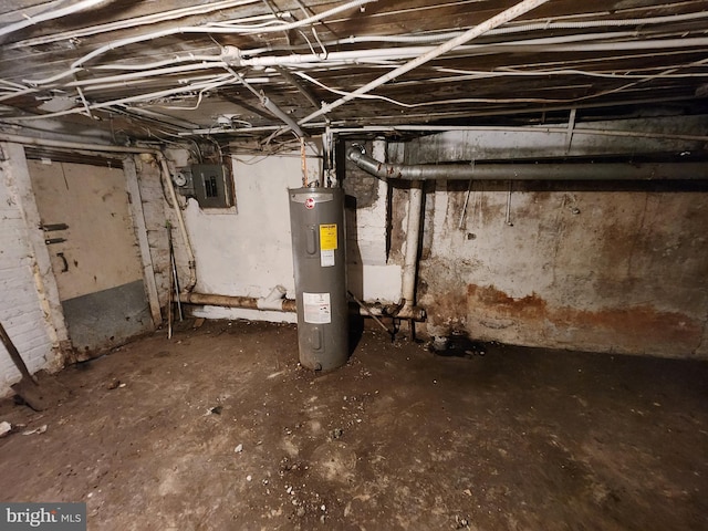 basement featuring electric panel and water heater