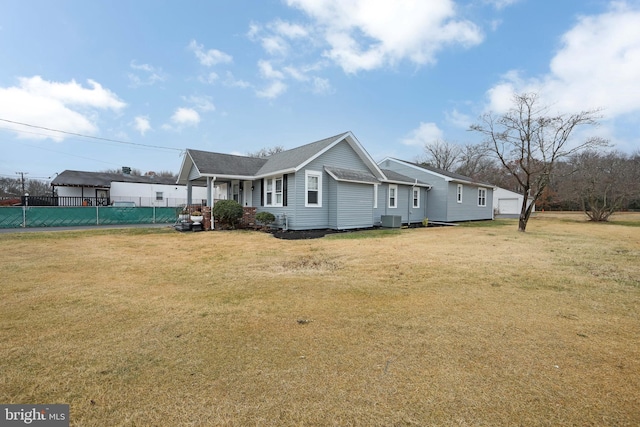 view of side of property with central air condition unit and a yard