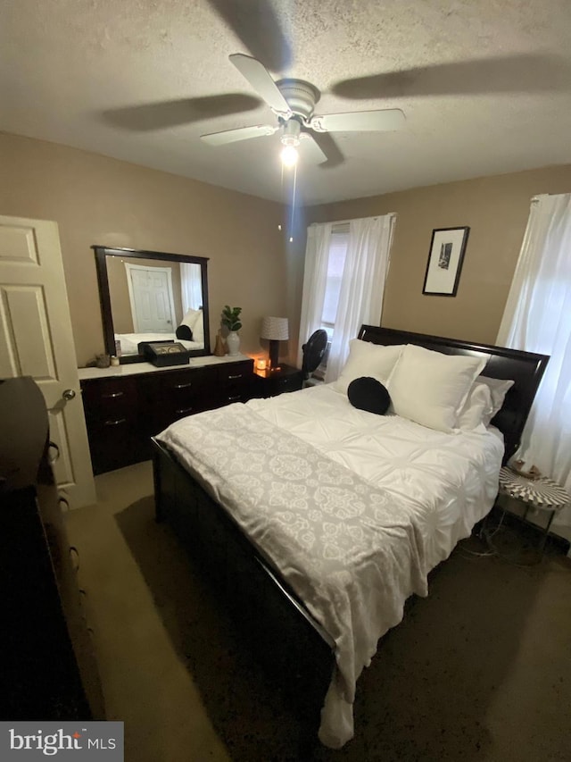 bedroom with carpet flooring, a textured ceiling, and ceiling fan