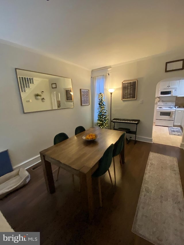 dining space featuring dark hardwood / wood-style floors