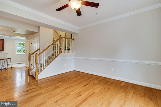 empty room featuring crown molding, ceiling fan, and light hardwood / wood-style floors