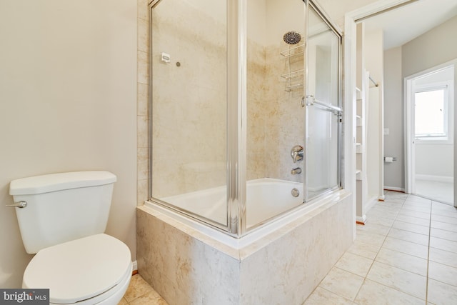 bathroom with toilet, tile patterned floors, and shower / bath combination with glass door