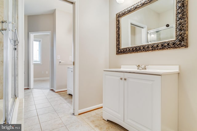 bathroom with tile patterned floors, vanity, and walk in shower