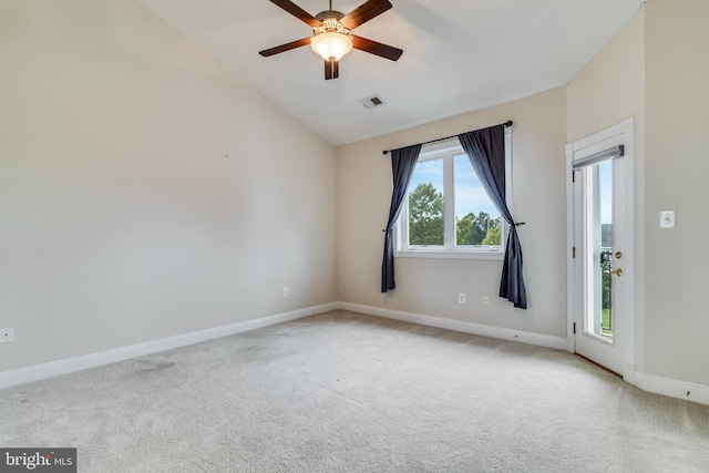 spare room with ceiling fan, light colored carpet, and lofted ceiling