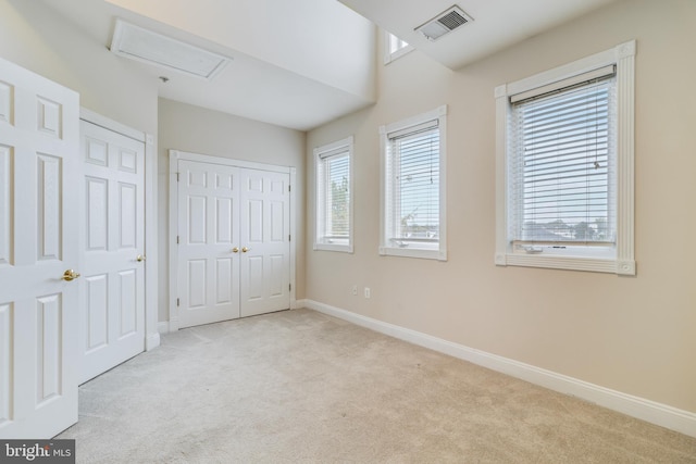 unfurnished bedroom with light colored carpet