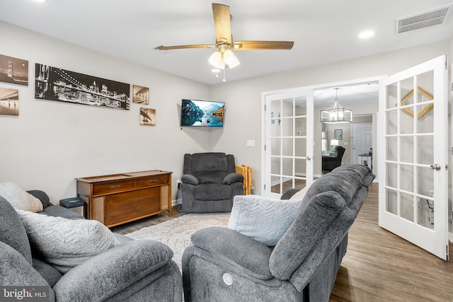 living room featuring hardwood / wood-style floors, french doors, and ceiling fan