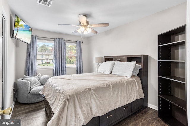 bedroom with ceiling fan and dark wood-type flooring