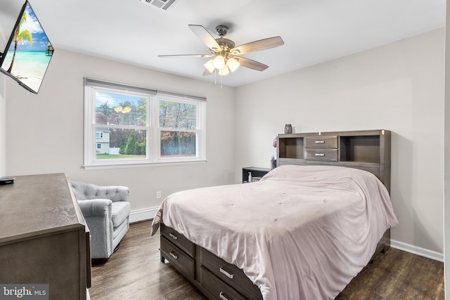 bedroom featuring ceiling fan, dark wood-type flooring, and a baseboard radiator