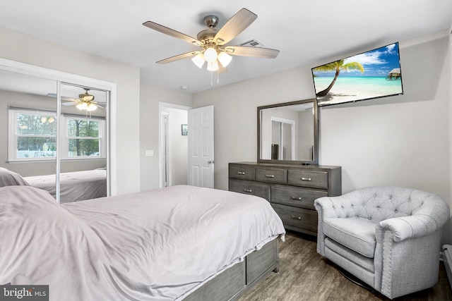 bedroom with ceiling fan, a closet, and dark wood-type flooring