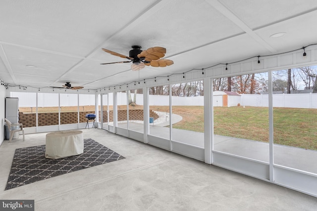 unfurnished sunroom with ceiling fan