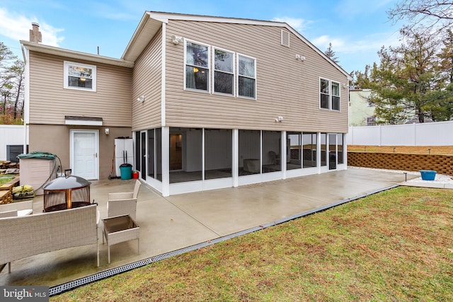 rear view of property featuring a lawn and a patio area