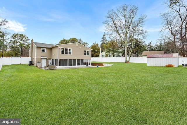 view of yard with a storage shed and a sunroom