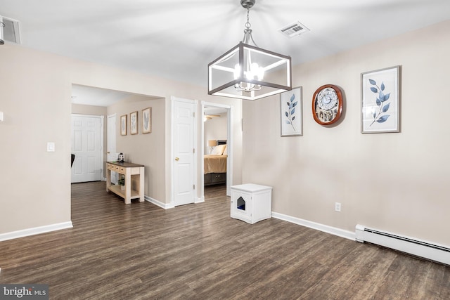 dining space featuring a chandelier, dark hardwood / wood-style flooring, and a baseboard radiator