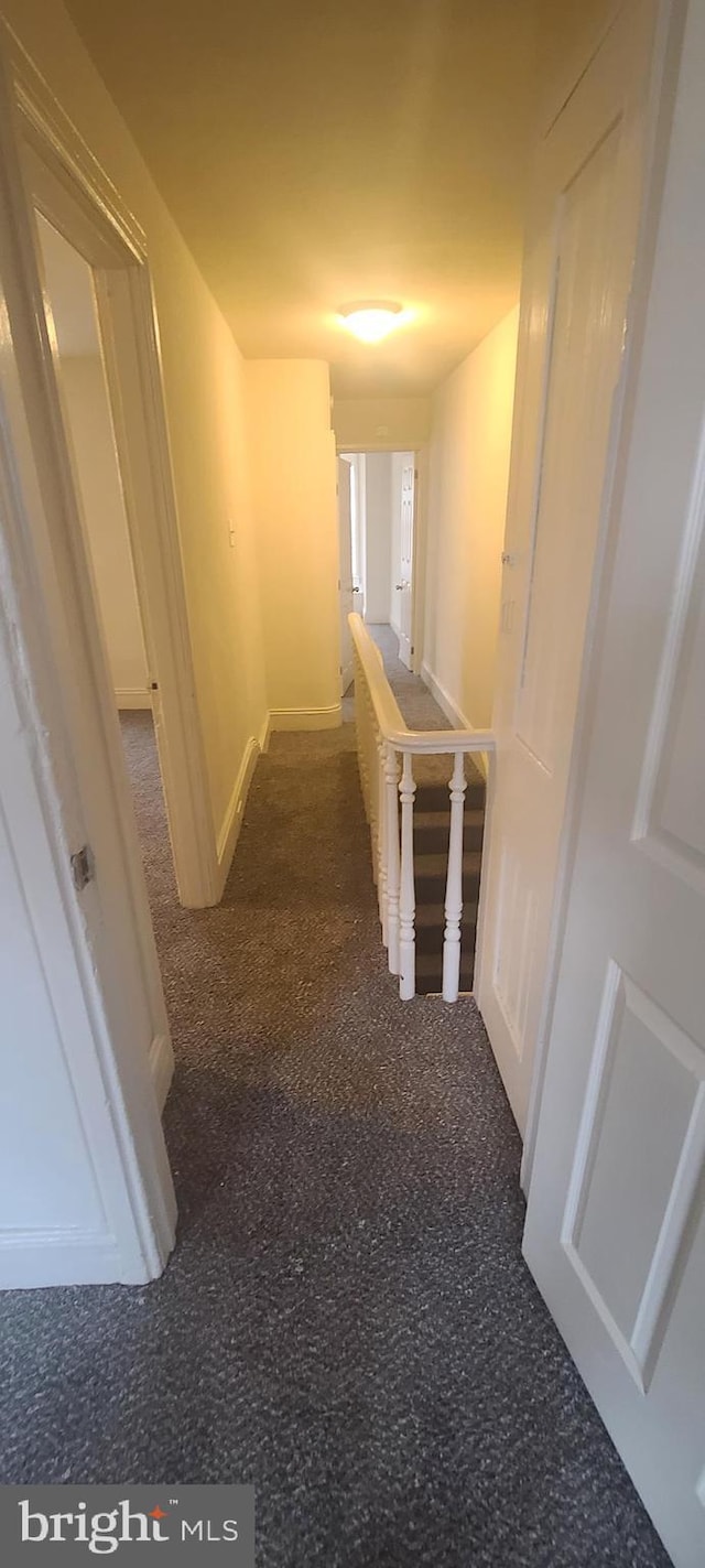 hallway with dark carpet