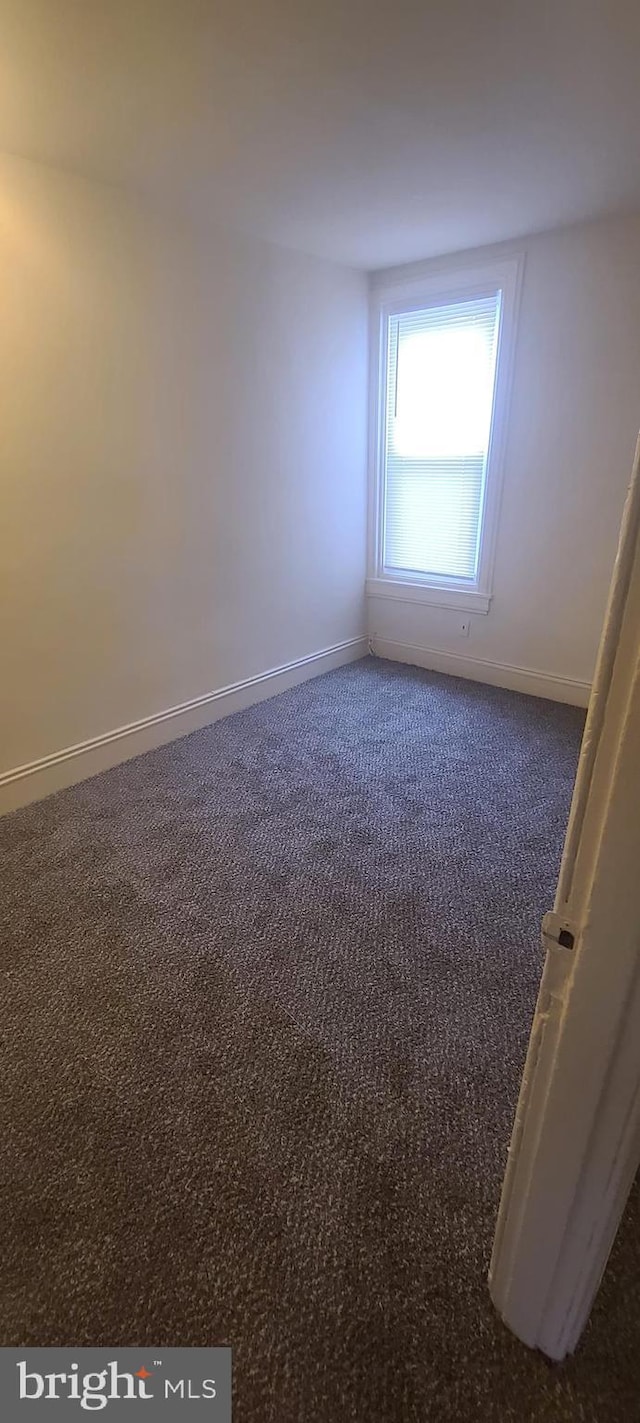 empty room with dark carpet