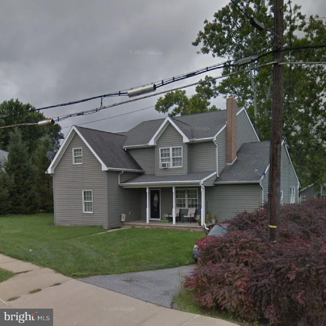 view of front facade with covered porch and a front lawn