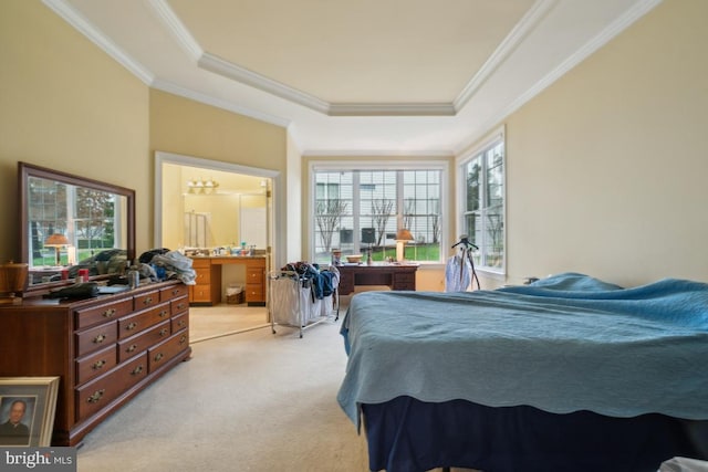 bedroom with ensuite bathroom, a raised ceiling, light carpet, and crown molding