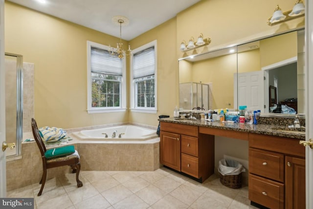 bathroom featuring tile patterned floors, vanity, shower with separate bathtub, and a notable chandelier