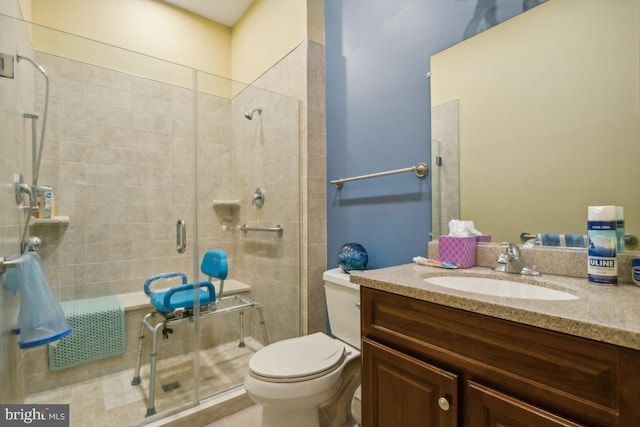 bathroom with vanity, toilet, and an enclosed shower