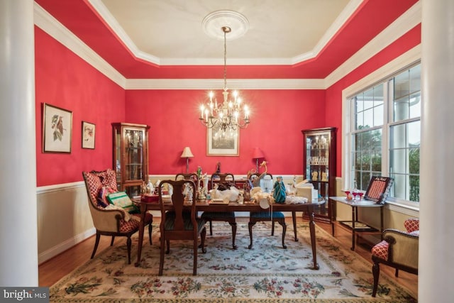 dining space with hardwood / wood-style flooring, crown molding, and a wealth of natural light