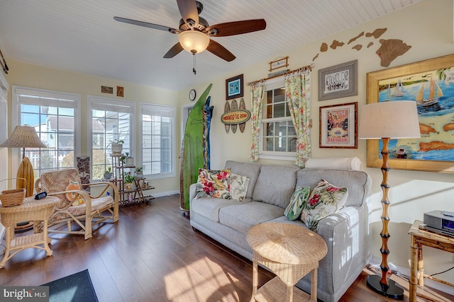 living room featuring ceiling fan and dark wood-type flooring