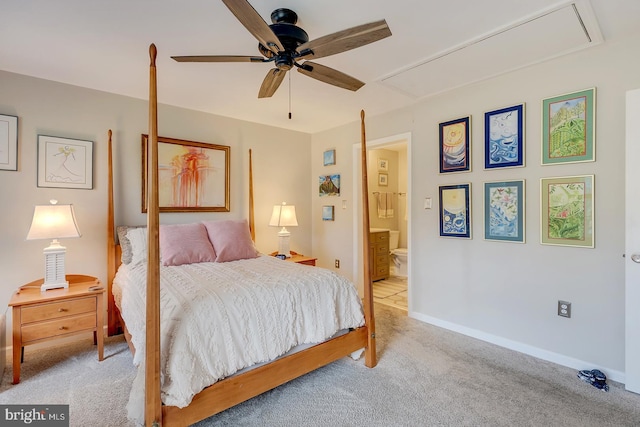 carpeted bedroom with ensuite bathroom and ceiling fan