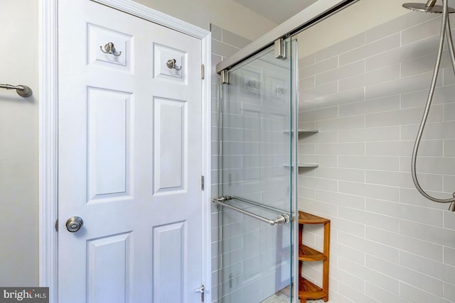 bathroom with a shower with shower door