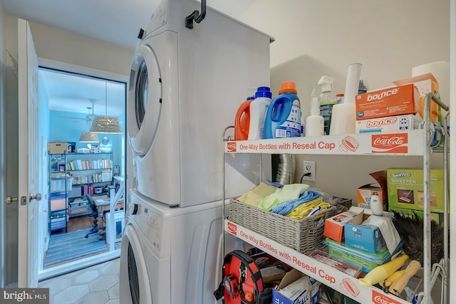 clothes washing area with stacked washer and clothes dryer