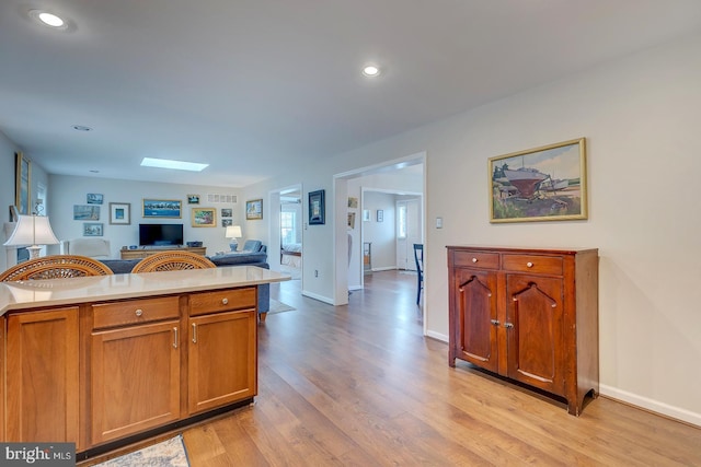 kitchen featuring light hardwood / wood-style flooring and a skylight