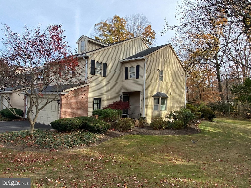 front of property with a garage and a front lawn