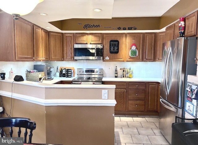 kitchen with stainless steel appliances, light tile patterned floors, and tasteful backsplash