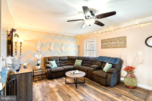 living room with a baseboard radiator, ceiling fan, crown molding, and hardwood / wood-style flooring