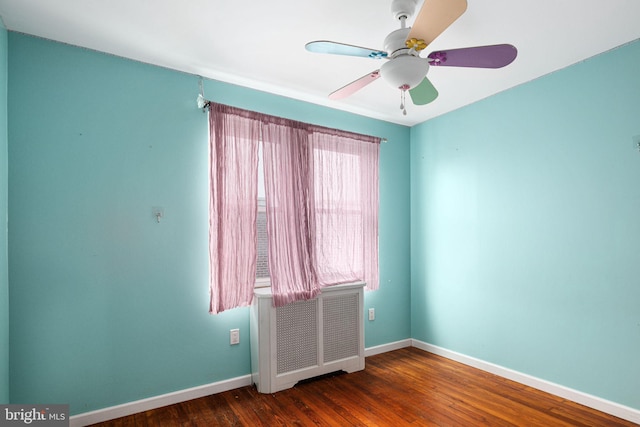 unfurnished room with ceiling fan and dark hardwood / wood-style flooring